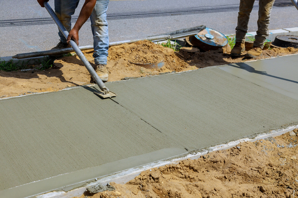 Process of installing construction of new sidewalks laying concrete cement
